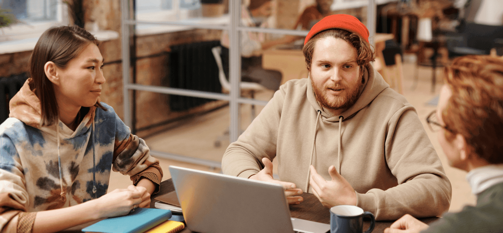 Team talking around a laptop in a meeting